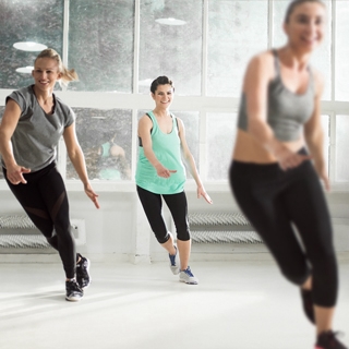 indoor gym class fitness group women exercise | Holmes Place